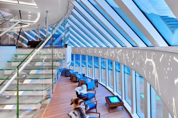 With two-story panoramic windows for maximum views, the Explorers' Lounge is inspired by epic journeys of discovery. This inviting space is the perfect place to share a cocktail with friends or relax while taking in the scenery.