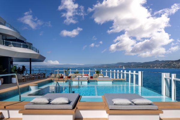 At the Beach House, bright, airy interiors flow into an expansive outdoor pool deck.