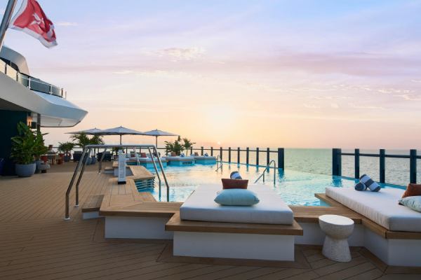 At Beach House, bright, airy interiors flow into an expansive outdoor pool deck, creating an effervescent setting.