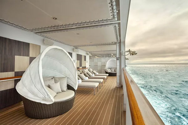 A tranquil open-air relaxation deck with infinite ocean views?, perfect for reflection before or after a treatment.