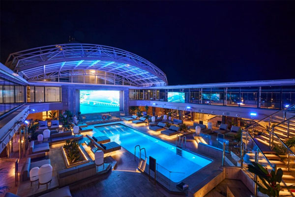 The Conservatory is a weather-protected poolside lounge by day. By night, it turns into a cinema experience under the stars. A relaxed, calming venue to unwind and enjoy cocktails, with light, lively background music playing throughout the day.
